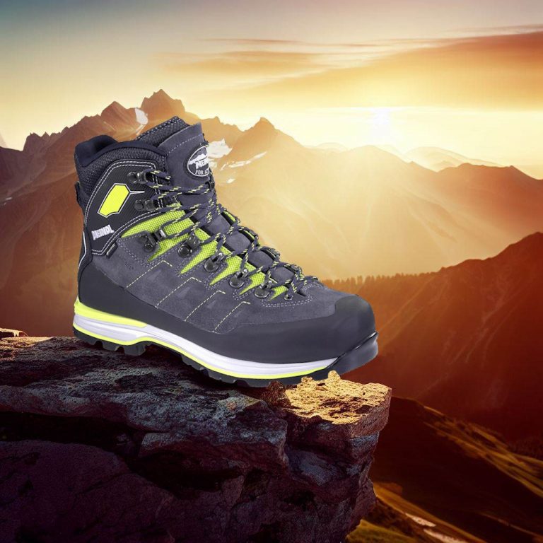 Hiking shoe on mountain peak in alpine sunset